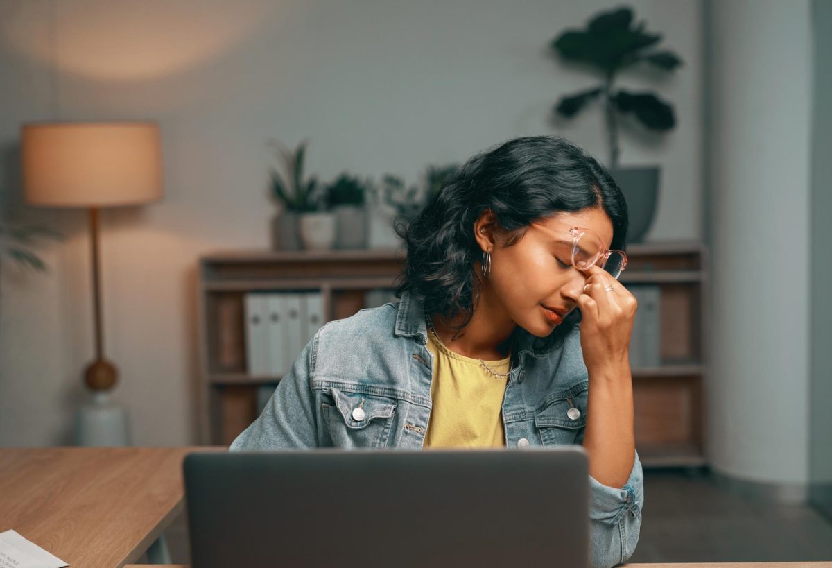 A stressed woman sits in front of a laptop. As finals week approaches, it is important to avoid burnout. (Getty Images)