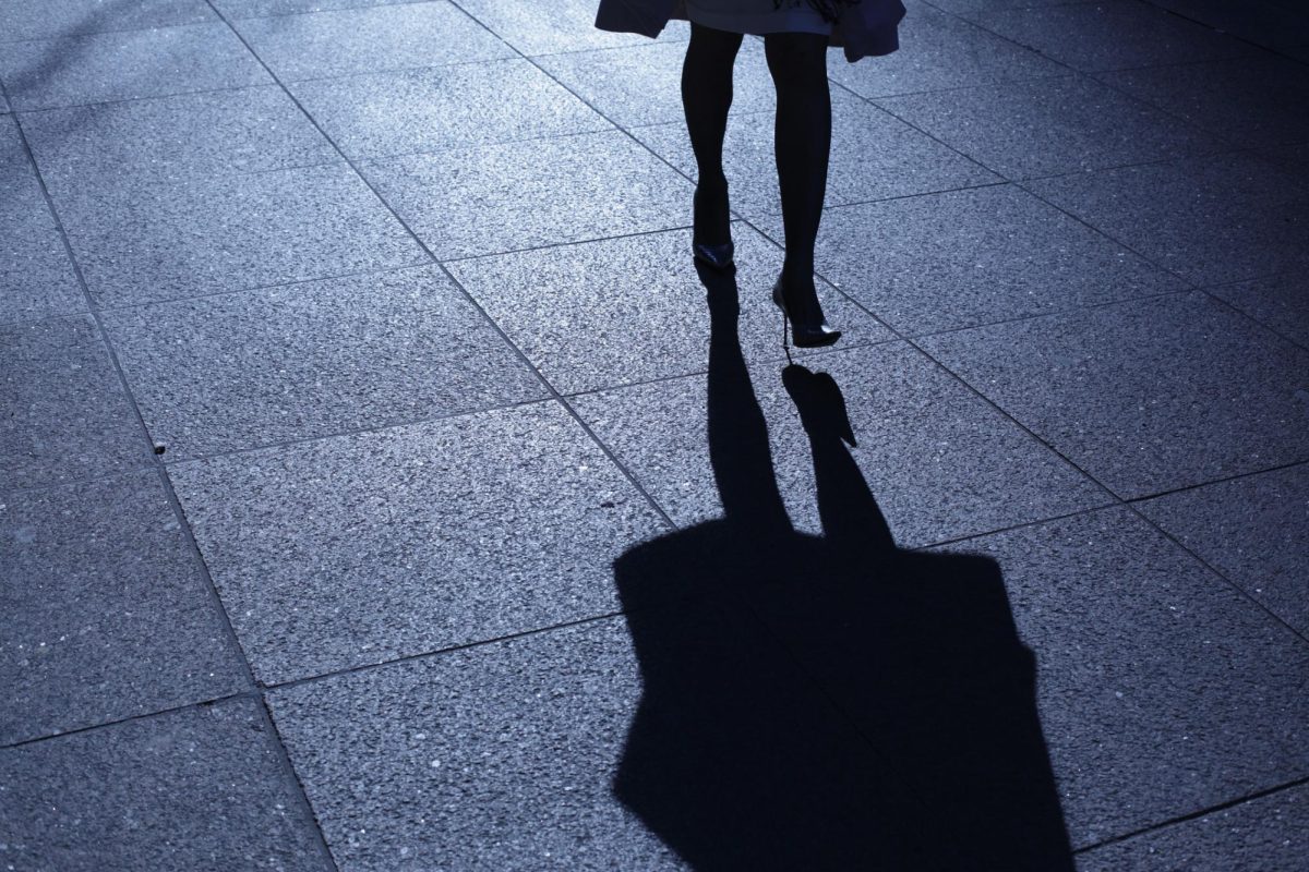 A figure walks in heels, casting a shadow on the ground. The Sigma Lambda Beta fraternity will host a Walk a Mile in Her Shoes event at 5 pm on April 4. (Courtesy of Getty Images)