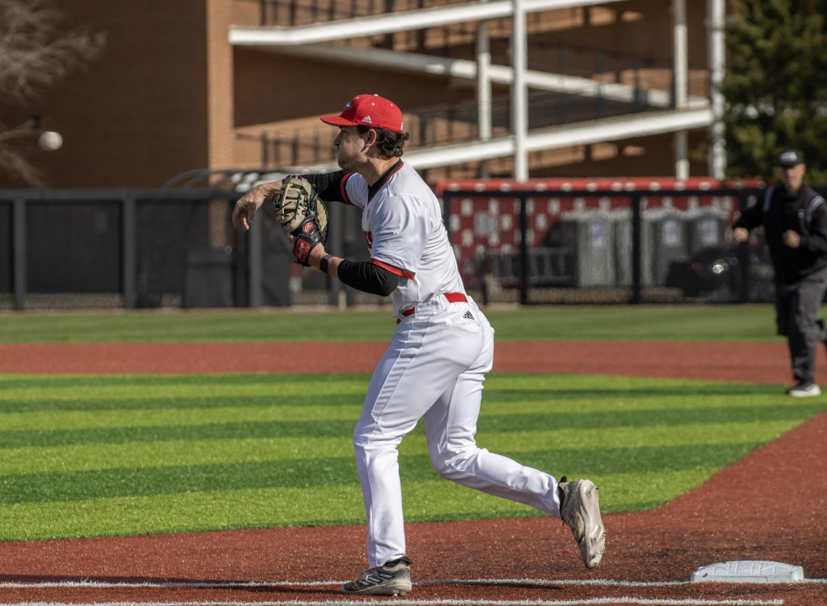 Senior+first+baseman+Mason+Kelley+%2818%29+throws+the+ball+to+the+catcher+at+home+plate+during+the+sixth+inning+of+an+NIU+baseball+game+against+Bowling+Green+State+University+on+April+6.+Kelley+scored+the+game-tying+run+in+the+ninth+inning+against+Kent+State+University+on+Saturday%2C+but+the+Huskies+fell+9-8+in+extra+innings.+%28Tim+Dodge+%7C+Northern+Star%29
