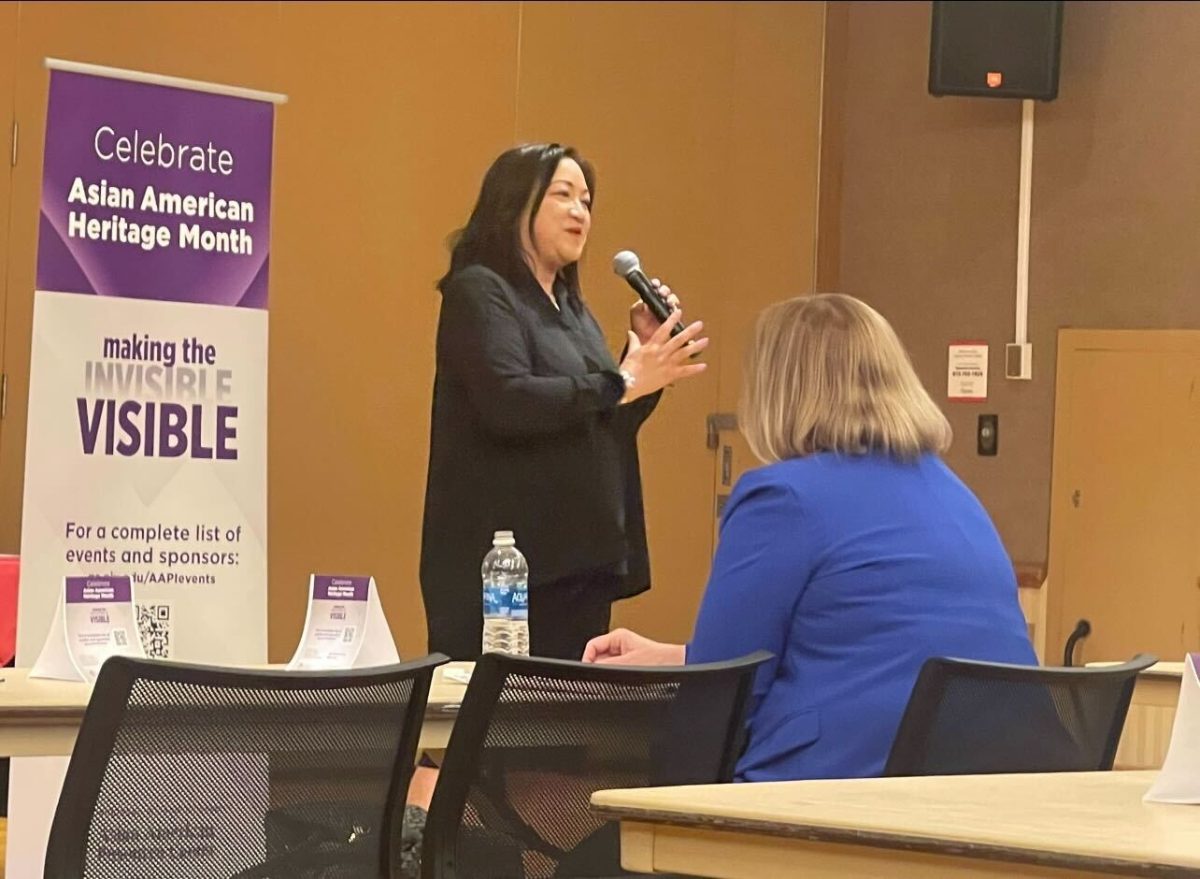 State Representative Theresa Mah stands and gives a speech during the Asian American in Politics event. Mah spoke about her experience becoming the first Asian American elected to serve in the Illinois General Assembly. (Emily Beebe | Northern Star)