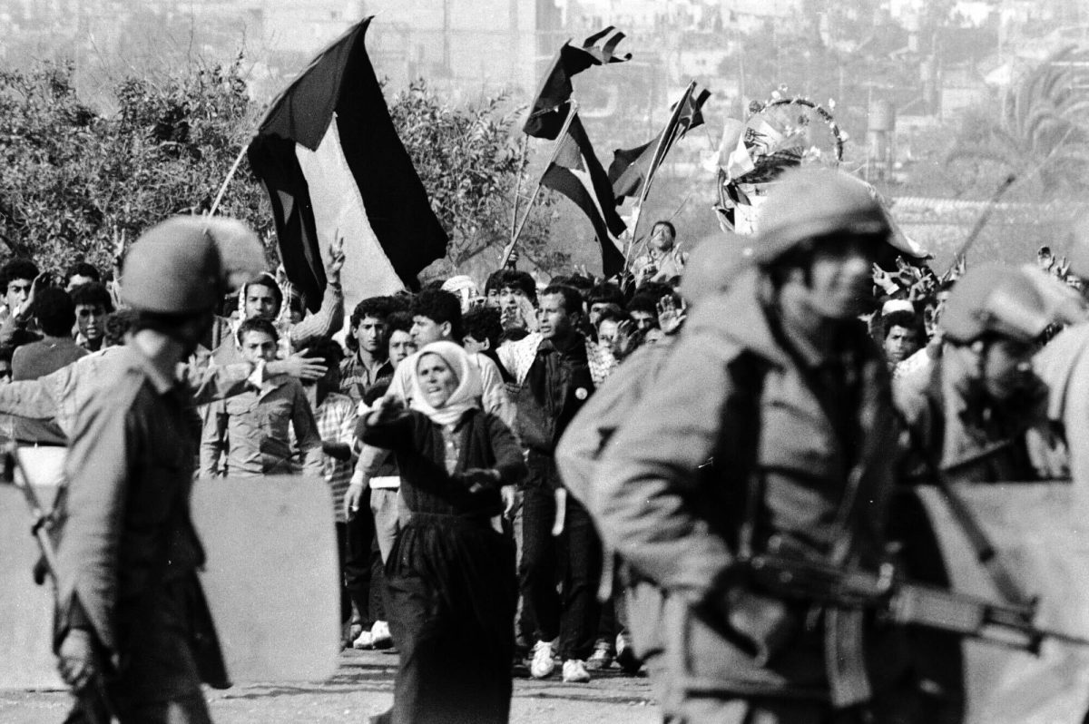 Protesters+march+with+Palestine+flags+during+the+first+intifada+in+Dec.+1987+within+the+Gaza+Strip.+Hamas+was+formed+as+a+Palestinian+militant+group+in+1987+by+Ahmed+Yassin+during+the+intifada%2C+which+was+a+Palestinian+rebellion+against+Israeli+occupation.+%28Efi+Sharir+%2F+Dan+Hadani+collection+%2F+National+Library+of+Israel+%2F+The+Pritzker+Family+National+Photography+Collection%29
