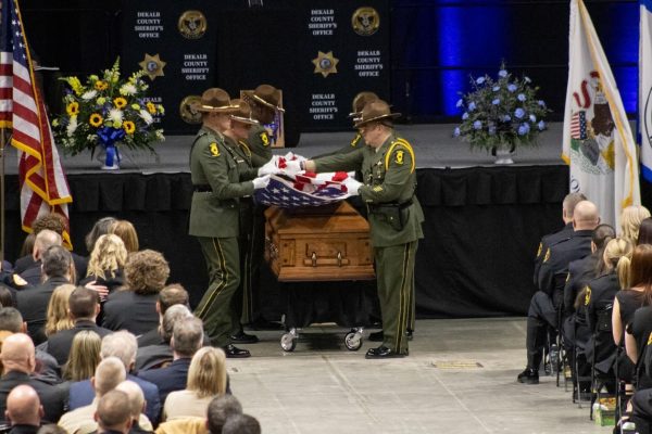 Illinois State Police carry a U.S. flag during Deputy Sheriff Christina Musils funeral service. There was a procession that took place after the funeral service. (Sean Reed | Northern Star)