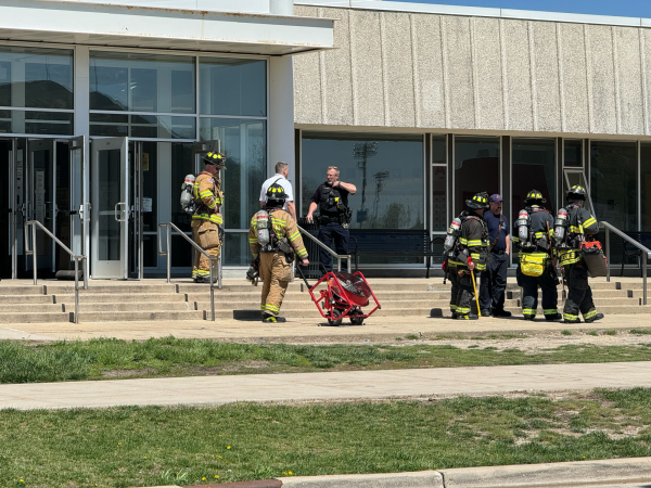 A group of firefighters stand outside the Stevenson South entrance. At approximately 12:15 p.m. students were evacuated out of the residence hall. (Gabby Crabtree | Northern Star)