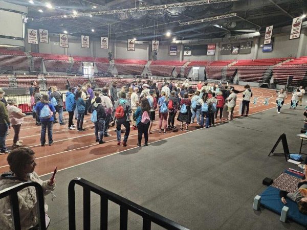 People gather at the start line for Walk A Mile in the Convocation Center. Saturday Safe Passage hosted their annual Walk A Mile event. (Kahlil Kambui | Northern Star)