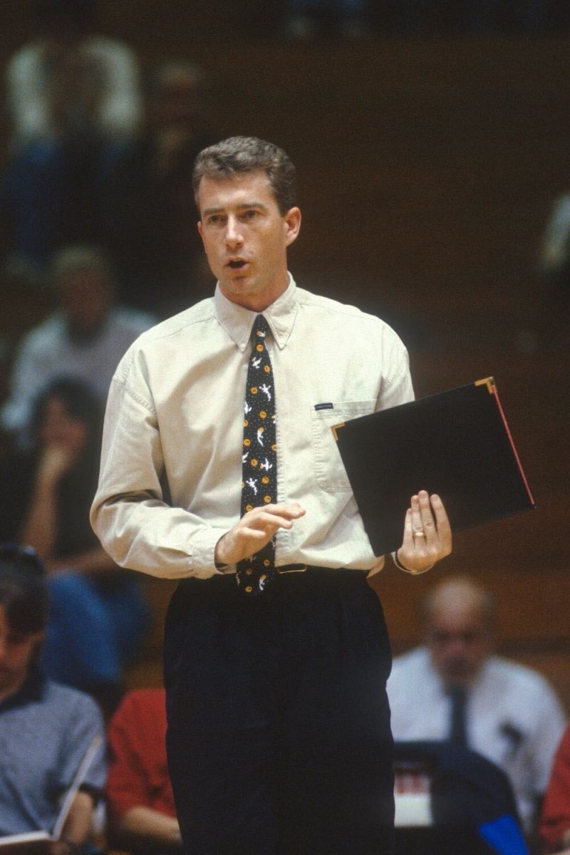 Then-NIU volleyball head coach Pete Waite stands courtside during a match. Waite will be inducted into the 2024 NIU Athletics Hall of Fame during Homecoming Weekend after leading the Huskies to a program-best .723 winning percentage during his 11 seasons as NIU’s head coach. (Courtesy of NIU Athletics)