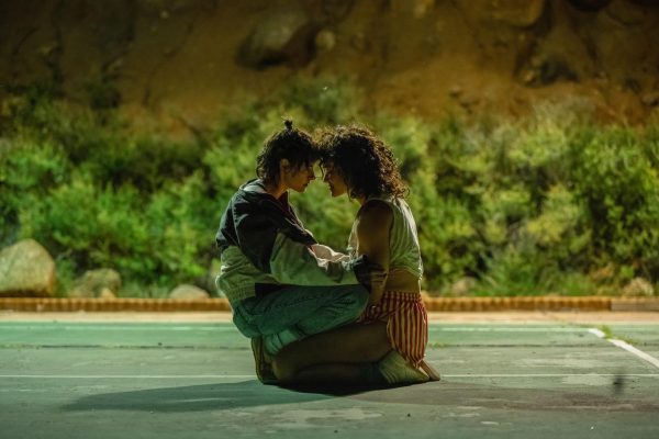 Kristen Stewart and Katy OBrian embrace in a scene from Love Lies Bleeding. The film follows two women as they explore body building, crime and family. (Anna Kooris | A24)