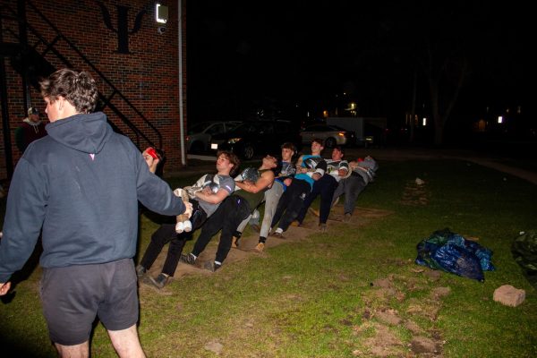 Seven Phi Kappa Psi members push off of their trench to resist the tug on the other side of a rope during practice at their fraternity house at 1020 W. Hillcrest Drive. The Interfraternity Council is set to host the 2024 IFC Mens Tugs event starting Monday at 4:30 p.m. (Totus Tuus Keely | Northern Star)