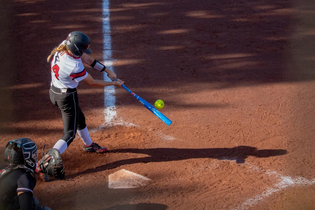 Junior middle infielder/outfielder Avery Carnahan hits an RBI single in the third inning of Game 2 on Tuesday. Carnahan drove in three runs on Tuesday as NIU softball split a doubleheader with Ball State University. (Totus Tuus Keely | Northern Star)