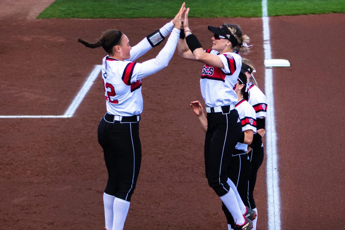Sophomore+pitcher%2Futility+Danielle+Stewart+%28left%29+and+senior+catcher%2Foutfielder+Ellis+Erickson+%28right%29+jump+up+for+a+high+five+during+pre-game+on+April+12.+NIU+softball+won+both+games+of+a+doubleheader+on+Wednesday+against+Valparaiso+University.+%28Northern+Star+File+Photo%29