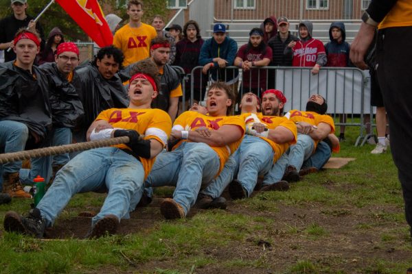 Delta Chi members leverage against the planks in their pits during the first match. The tuggers wore trash bag ponchos during the rain while they were not tugging to help keep their duct tape sleeves dry and retain traction. (Totus Tuus Keely | Northern Star)

