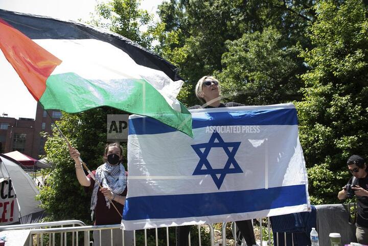 Pro-Palestine and pro-Israel protesters wave the Palestine and Israel flags in opposing demonstrations at George Washington University in Washington on Sunday. The Hamas-Israel conflict is sparking protests across the nation. (AP Photo/Cliff Owen)