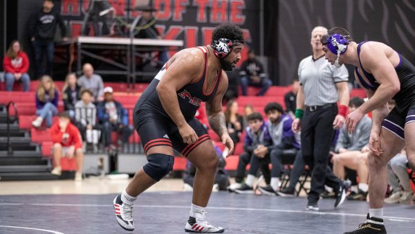 Redshirt sophomore heavyweight wrestler Jacobi Jackson scans his opponent in an NIU wrestling home match. Jackson suffered two major injuries before finishing his 2023-2024 season as a ranked wrestler. (Courtesy of NIU Athletics)