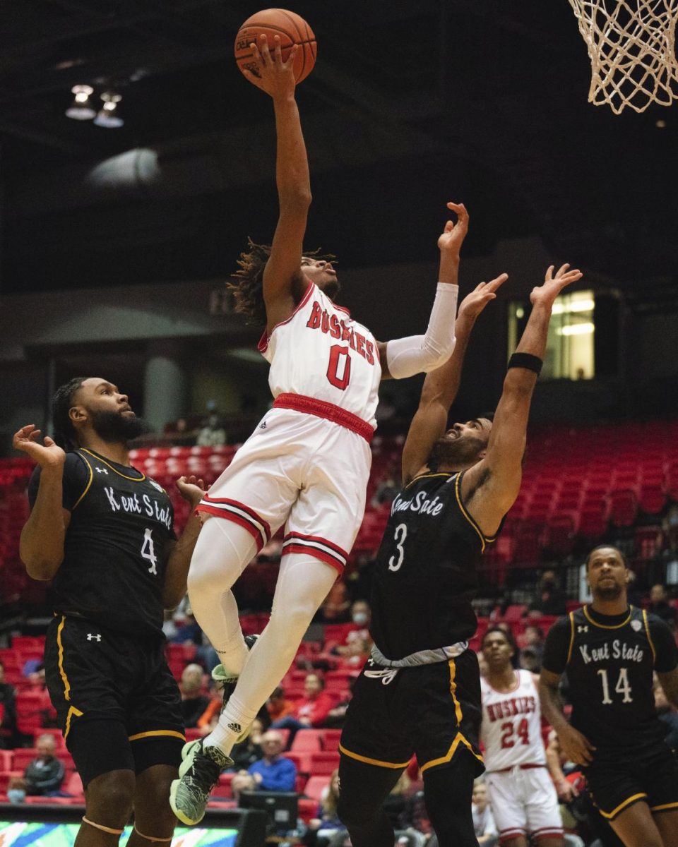 Then-sophomore guard Keshawn Williams (0) shoots a layup over Kent State Universitys then-redshirt junior guard Sincere Carry on March 1, 2022 at the NIU Convocation Center in DeKalb. Williams announced on his Instagram Monday that he will be transferring to Colorado State University for the 2024-25 season. (Northern Star File Photo)