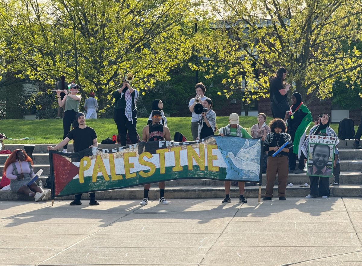 NIU Students stand on the stairs outside MLK Commons and protest in solidarity with Palestine. Students plan to occupy the stairs until the university meets their six demands. (Gabby Crabtree | Northern Star)