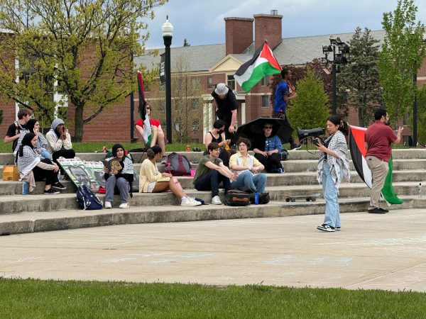 Student Pro-Palestine protesters sit and shout “Free, Free, Free Palestine,” on Thursday. NIU students are protesting for the second day in a row. (Gabby Crabtree | Northern Star)