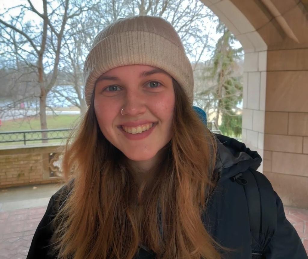 Allison Spotts stands outside in a jacket and beanie hat. Spotts attended DeKalb High School and will graduate with a bachelors degree in Kinesiology. (Rachel Cormier | Northern Star)