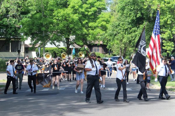 Members of DeKalb American Legion Post 66 and the DeKalb High School Marching Barbs march with musical instruments and flags during the 2023 Memorial Day Parade in DeKalb. The 2024 Memorial Day Parade will take place May 27. (Courtesy of the City of DeKalb)