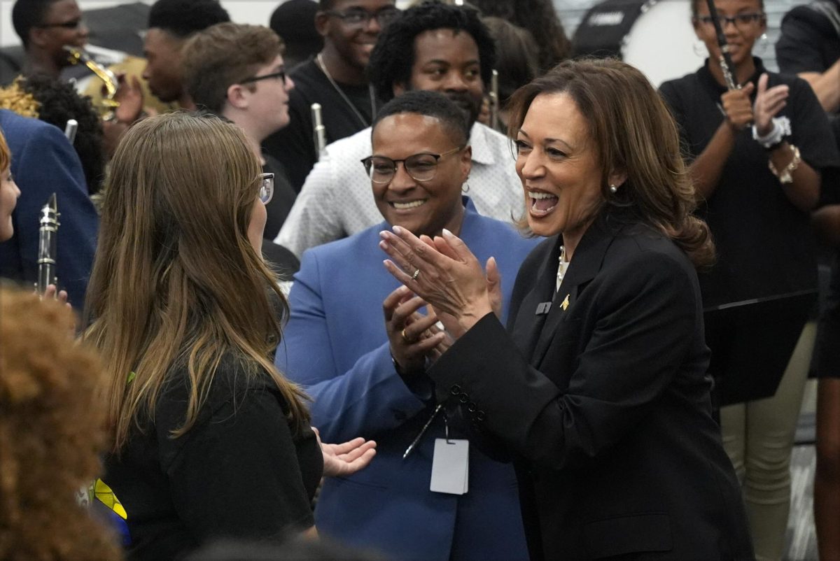 Democratic presidential nominee Vice President Kamala Harris talks with Liberty County High School marching band members Wednesday in Hinesville, Georgia. Popular social media platforms are among the tools the Harris Walz campaign is using to generate engagement with young, Gen Z voters. (AP Photo/Jacquelyn Martin)