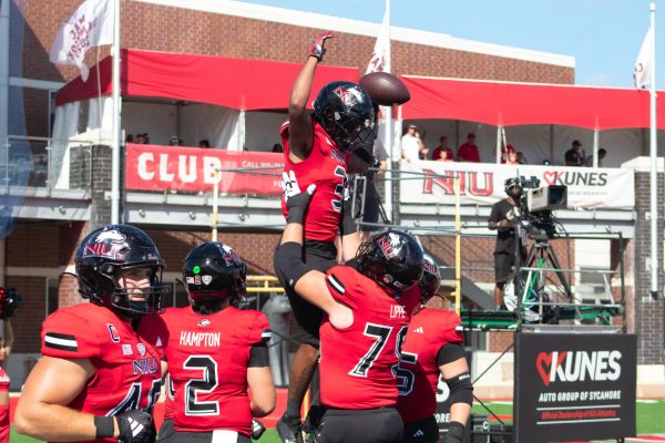 Redshirt-senior wide receiver Trayvon Rudolph (3) is lifted up in celebration after a touchdown Saturday at Huskie Stadium. Rudolph scored two touchdowns in the first half as NIU defeated Western Illinois University 54-15. (Totus Tuus Keely | Northern Star)