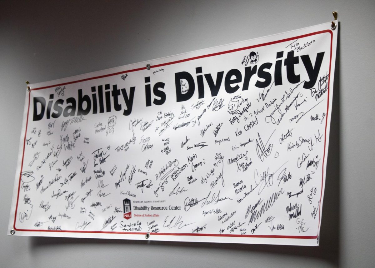 A sign that reads "Disability is Diversity" hangs on a wall in the Disability Resource Center. The Communication Access Realtime Translation (CART) is a new service through the DRC that provides captioning for students with hearing impairments. (Ethan Rodriguez | Northern Star)