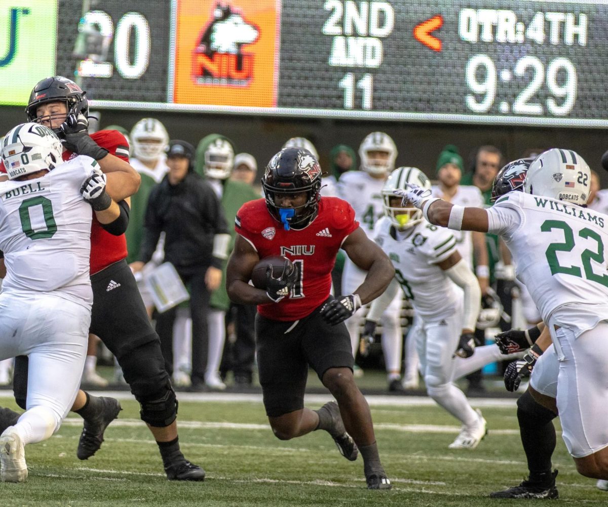 Then-junior running back Antario Brown (1) carries the ball in the fourth quarter of NIU’s 116th Homecoming Game against Ohio University on Oct. 14, 2023. Back for his senior season, Brown is poised to play a large role in NIU’s run-heavy offense. (Tim Dodge | Northern Star)