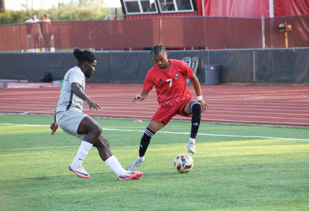 Senior forward Zachariah Thomas (7) dribbles the ball around a Chicago State University defender on Sunday at the NIU Soccer and Track & Field Complex. NIU men's soccer lost 5-1 Thursday to the University of Memphis. (Courtesy of NIU Athletics)