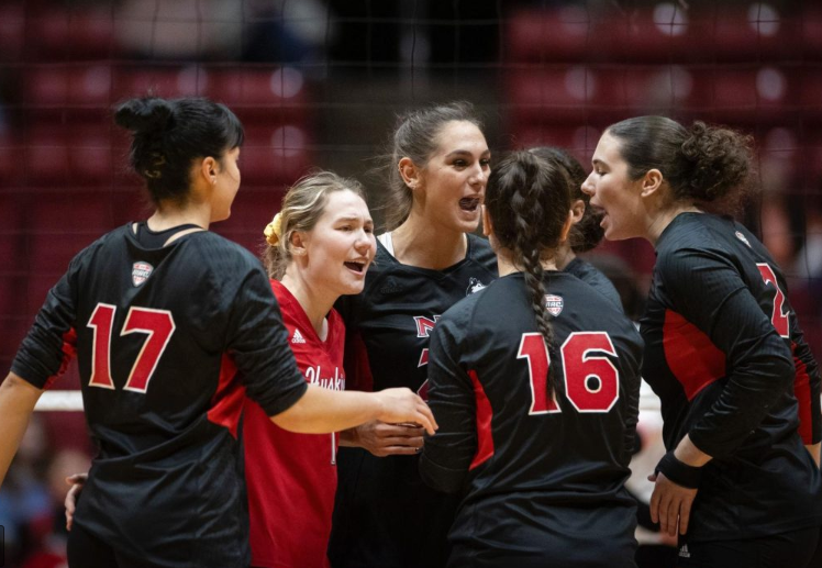 Members of the NIU volleyball team huddle on Nov. 11, 2023, during a road match at Ball State University in Muncie, Indiana. The Huskies begin the 2024 season Friday. (Northern Star File Photo)