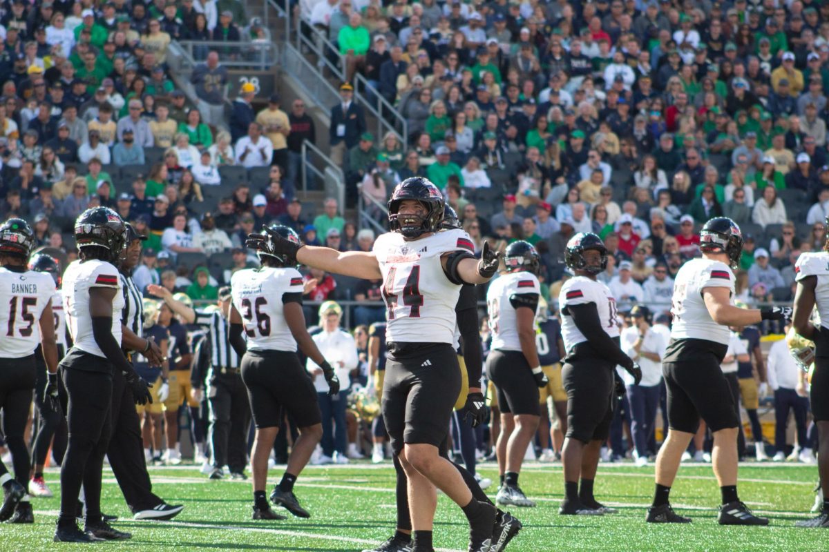 Senior linebacker Christian Fuhrman (44) celebrates through the wave of booing from University of Notre Dame fans on Saturday. The NIU football team has received many awards, both team and individual, since its win over Notre Dame.  (Totus Tuus Keely | Northern Star)