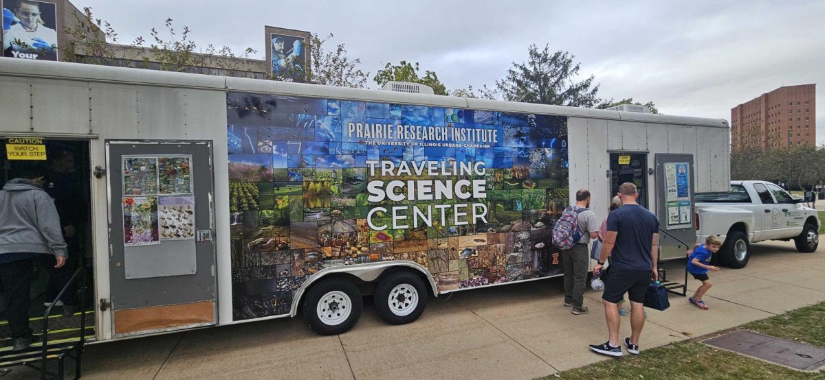 A trailer reads "Prairie Research Institute, The University of Illinois Urbana-Champaign Traveling Science Center." NIU held its 15th annual STEM Fest event from 10 a.m. to 3 p.m. Saturday at the Holmes Student Center. (Kahlil Kambui | Northern Star)