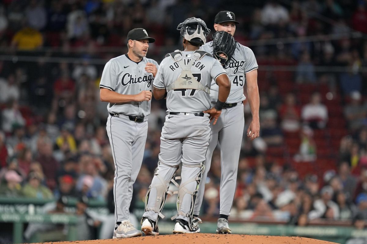 Chicago White Sox pitching coach Ethan Katz (from left), comes to the mound to talk with catcher Chuckie Robinson (47) and starting pitcher Garrett Crochet (45) during the first inning against the Boston Red Sox on Saturday in Boston, Massachusetts. Sports Reporter Joseph Segreti believes the 2024 White Sox are among the worst teams in Major League Baseball history. (Michael Dwyer | AP Photo)