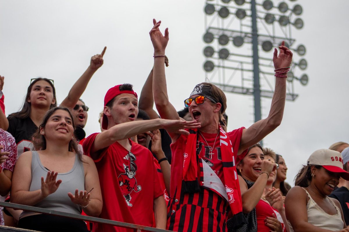  NIU student fans celebrate after NIU stops Buffalo at only a 1-yard pass for their second play of the game. NIU fans stayed loud until the stadium went quiet after Buffalo’s completed field goal to win. (Totus Tuus Keely | Northern Star)