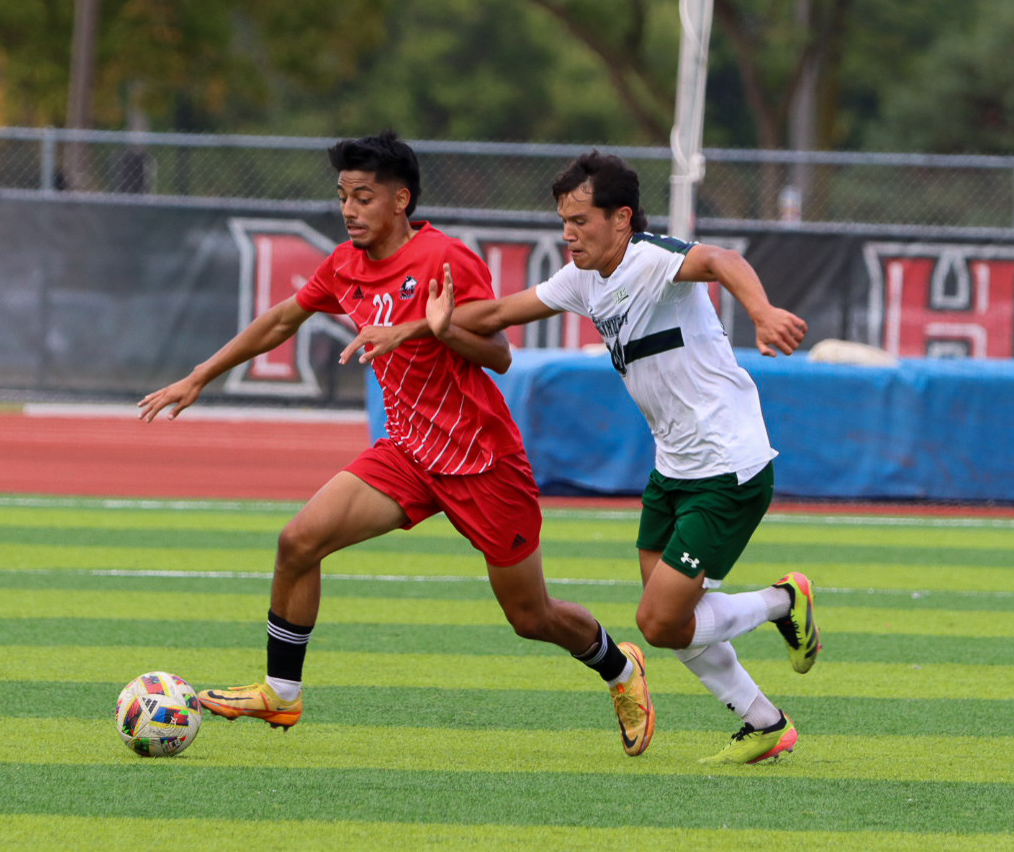 Redshirt freshman midfielder Joe Hernandez (22) fights to gain possession of the ball against Mercyhurst senior midfielder Callum Cleary (20) on Monday at the NIU Soccer and Track & Field Complex. NIU men's soccer lost 4-0 to Western Illinois University on Friday. (Marco Alvarez | Northern Star)