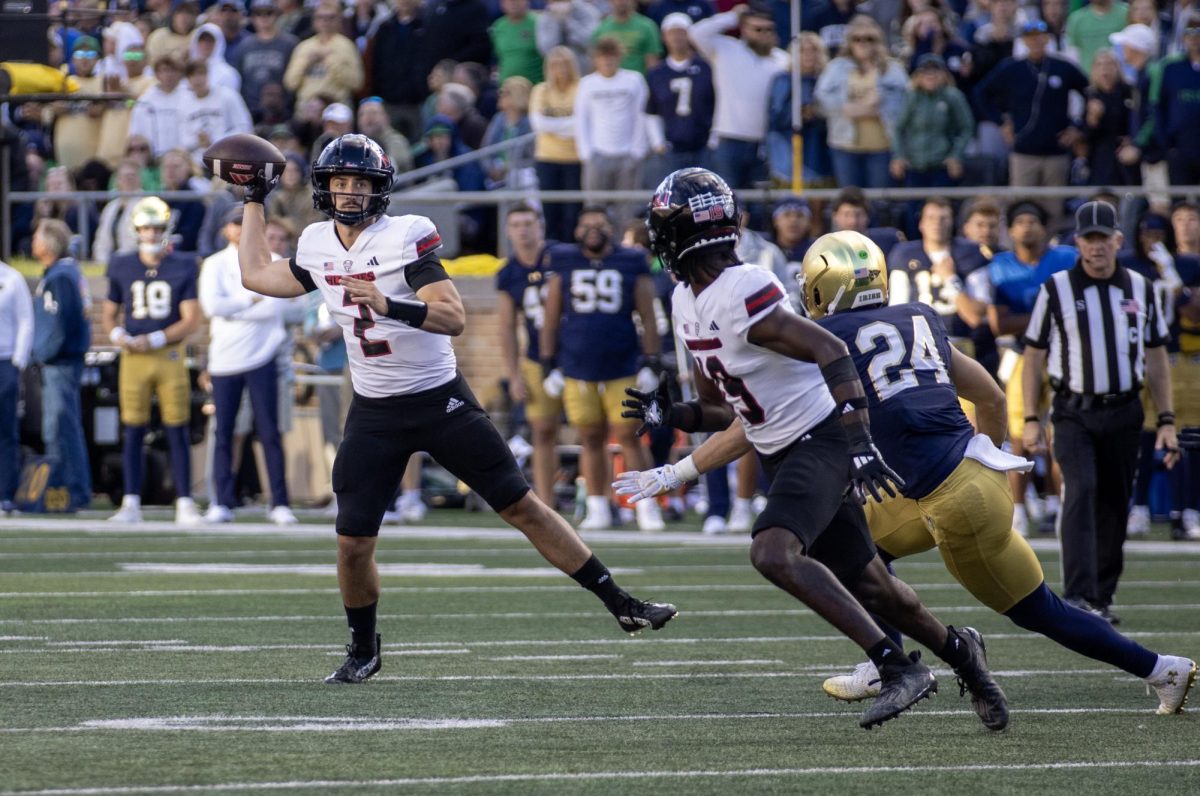 NIU redshirt junior quarterback Ethan Hampton (2) passes to senior wide receiver Andrew McElroy (19) late in the fourth quarter of a 16-14 victory over the University of Notre Dame on Sept. 7 at Notre Dame Stadium. Hampton was 10-of-19 passing for 198 yards and a touchdown. (Tim Dodge | Northern Star)