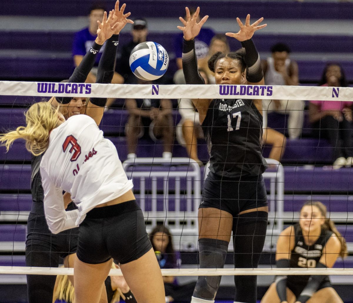 Freshman outside hitter Ava Grevengoed (3) spikes over the net into Northwestern University's blockers on Wednesday at Welsh-Ryan Arena. Grevengoed led NIU volleyball in kills with 10 as the Huskies were defeated in three sets by Northwestern on Wednesday. (Tim Dodge | Northern Star)