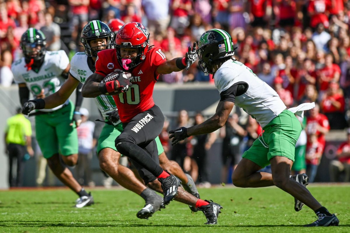 North Carolina State University then-freshman wide receiver Kevin “KC” Concepcion (10) stiff arms Marshall University then-junior defensive back Josh Moten during the second quarter of NC State’s 48-41 victory on Oct. 7, 2023, at Carter-Finley Stadium in Raleigh, North Carolina. Concepcion finished his freshman season with 71 catches for 839 yards and 10 touchdowns to earn Atlantic Coast Conference Rookie of the Year and Offensive Rookie of the Year honors. (Hallie Walker | Technician)