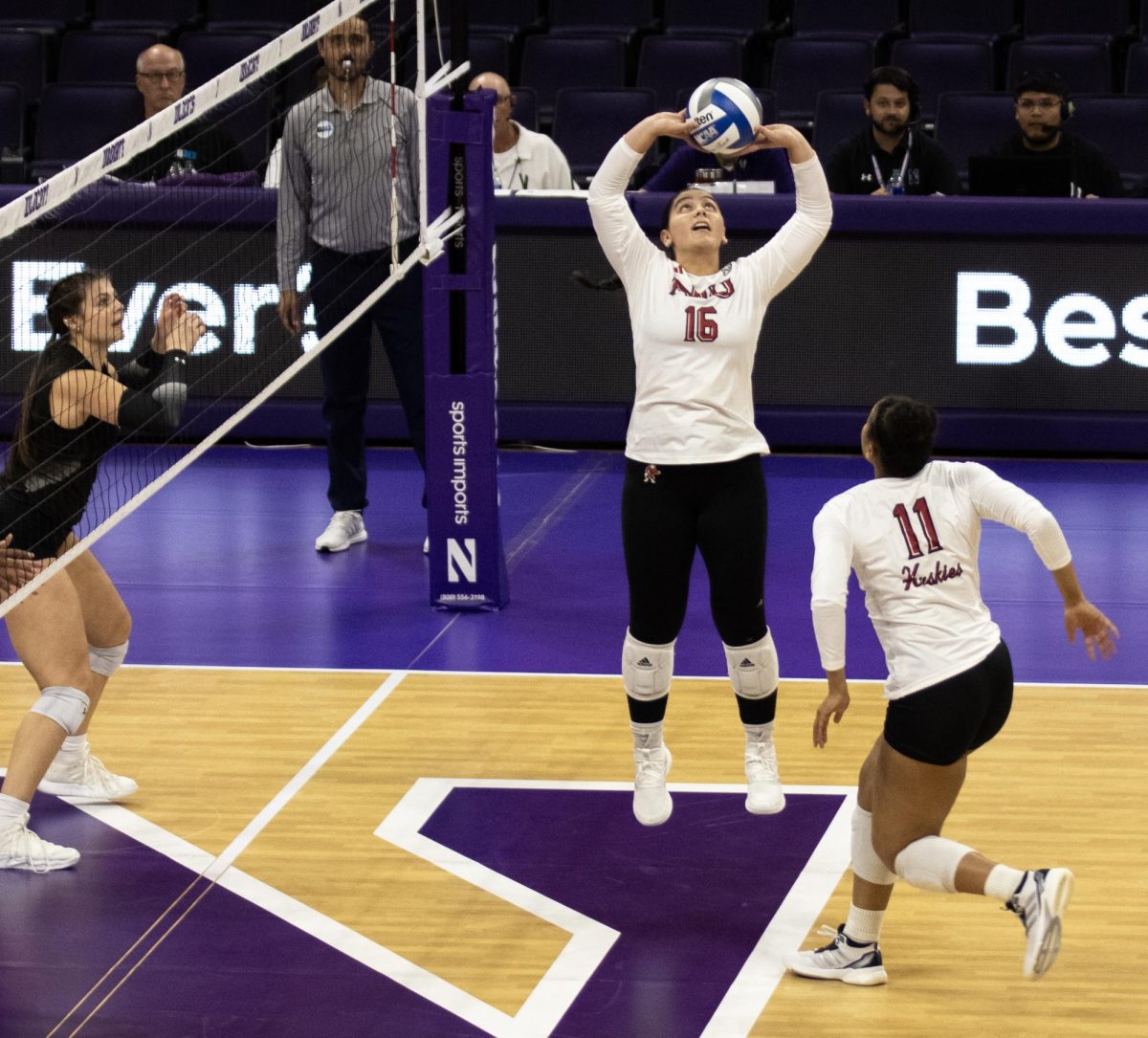 Senior setter Sophie Hurt (16) sets the ball to senior middle blocker Charli Atiemo (11) on Wednesday at Welsh-Ryan Arena. NIU volleyball was swept by Northwestern University for the second match in a row on Friday. (Northern Star File Photo)