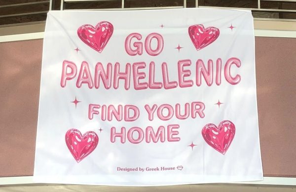 A sign stating “GO PANHELLENIC” hangs in the Peters Campus Life Building. The formal recruitment process for Panhellenic sororities will take place from Sept. 27-29. (Jenny Javkhlantugs | Northern Star)