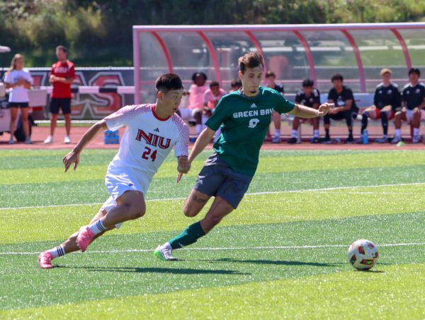 Senior defender Ben Suddeth (24) battles for possession with University of Wisconsin-Green Bay junior forward Chris Album (9) Sunday at the NIU Soccer and Track & Field Complex. NIU men's soccer lost 2-1 to Green Bay, losing for the second game in a row. (Marco Alvarez | Northern Star)