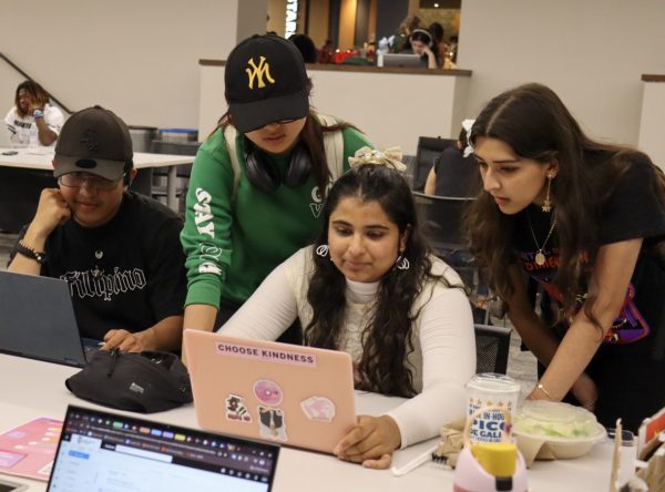 Jonathan Venecia (from left), a senior psychology major, Paw Hsi Hser, a junior business administration major, Noor Dogar, a junior early childhood education major, and Karina Lopez Rodriguez, a junior marketing major, interact together on a laptop in the Holmes Student Center. Having friends is a crucial part of life and it is important to keep those friendships healthy. (Marco Alvarez | Northern Star)