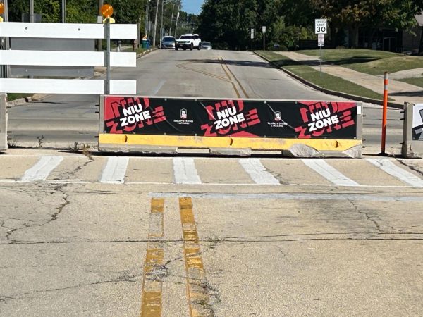 A barricade that reads NIU Zone sits on Normal Road. The roundabout at the intersection of Normal Road and Lucinda Avenue is expected to be completed by August 2025. (Emily Beebe | Northern Star)