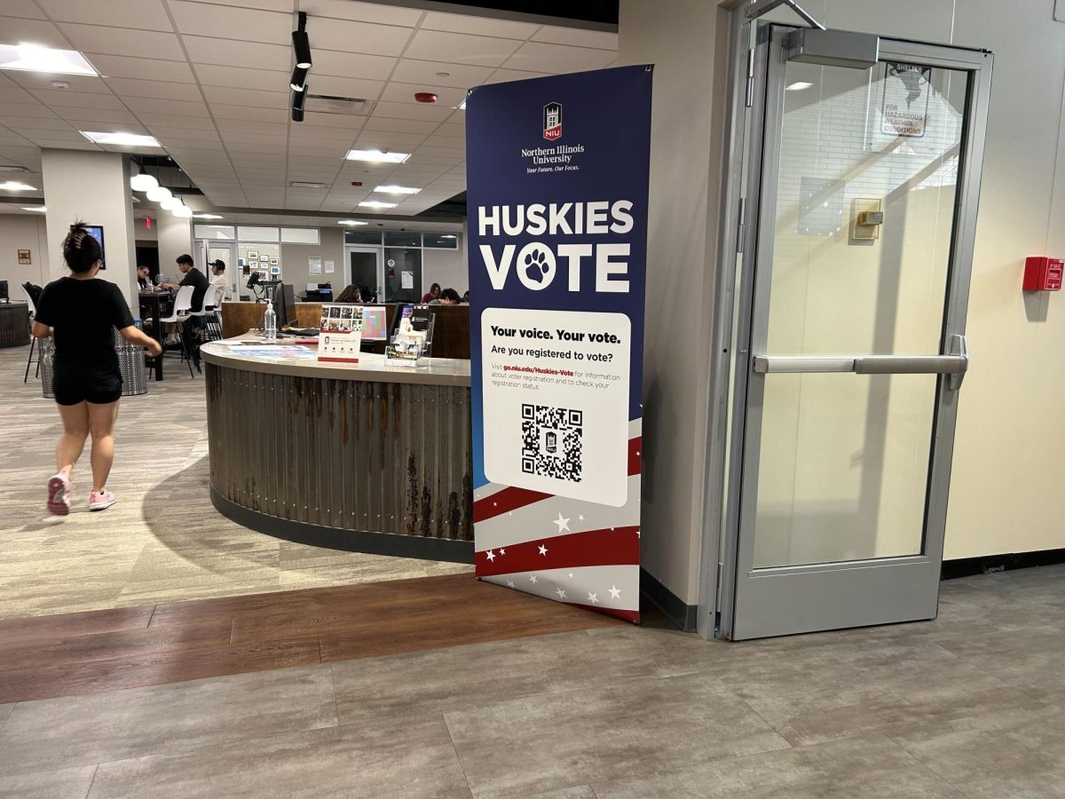 A banner that reads "Huskies Vote" sits in the Holmes Student Center. The Huskies Vote initiative encourages students to register to vote in elections. (Emily Beebe | Northern Star)