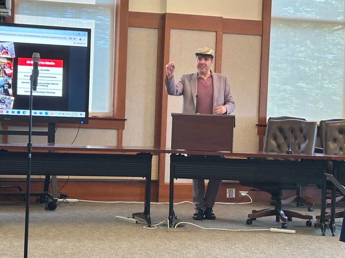 Clint-Michael Reneau, vice president of student affairs, gives a presentation at the University Council meeting Wednesday. Reneau gave a presentation on NIU’s strategic plan regarding health and well-being. (Emily Beebe | Northern Star)