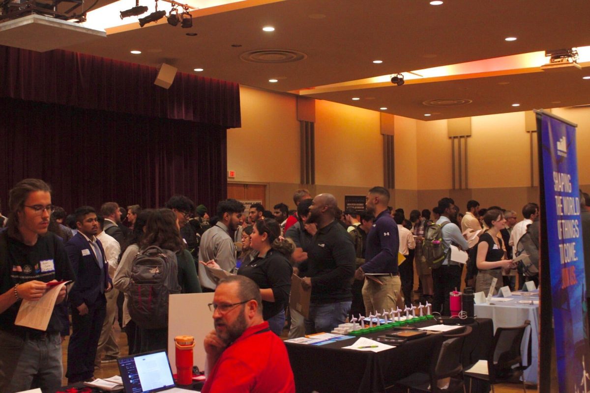 A group of students gather at the STEM/IT Fair hosted in the Duke Ellington Ballroom on Wednesday. The IT/STEM Fair provides students in those fields the opportunity to connect with potential employers. (Ethan Rodriguez | Northern Star)