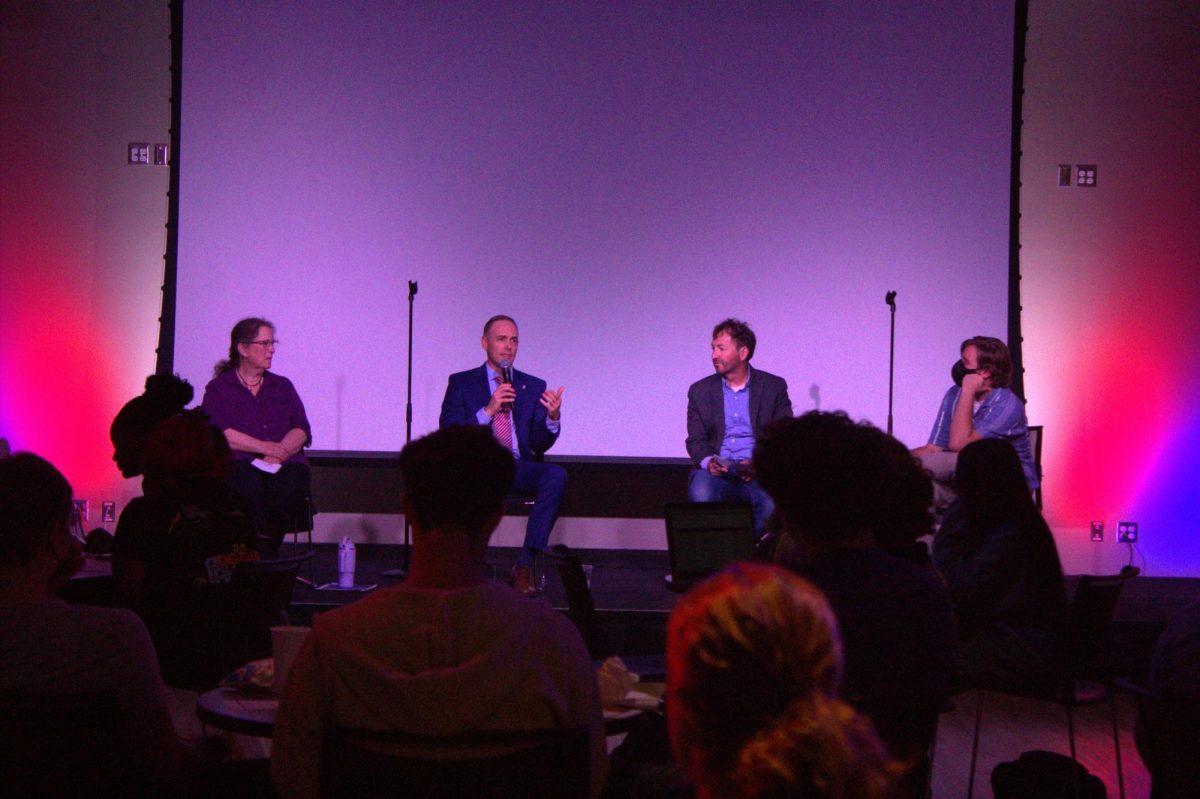 Panelists Cynthia de Seife (from left), Matt Streb, Mitchell Pickerill, and WNIJ’s Education Policy Reporter Peter Medlin, discuss current political issues prior to the commencement of the presidential debate Tuesday. Panelists discussed topics including abortion, quality housing and student loans, among others. (Brooke Schliephake | Northern Star)