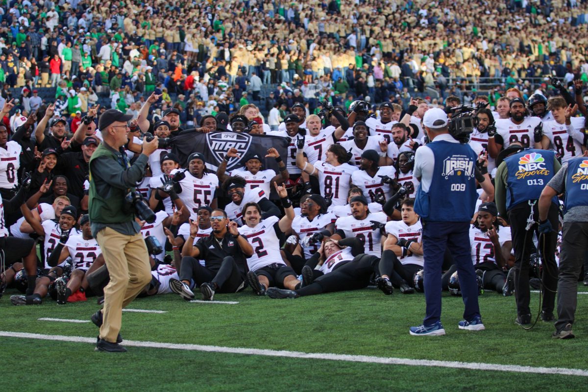 The NIU football team takes a group photo together on the field at the University of Notre Dame after their 16-14 victory Saturday. NIU will have a bye week before returning home Sept. 21 as the Huskies host University of Buffalo in their Mid-American Conference opener. (Tim Dodge | Northern Star)  
