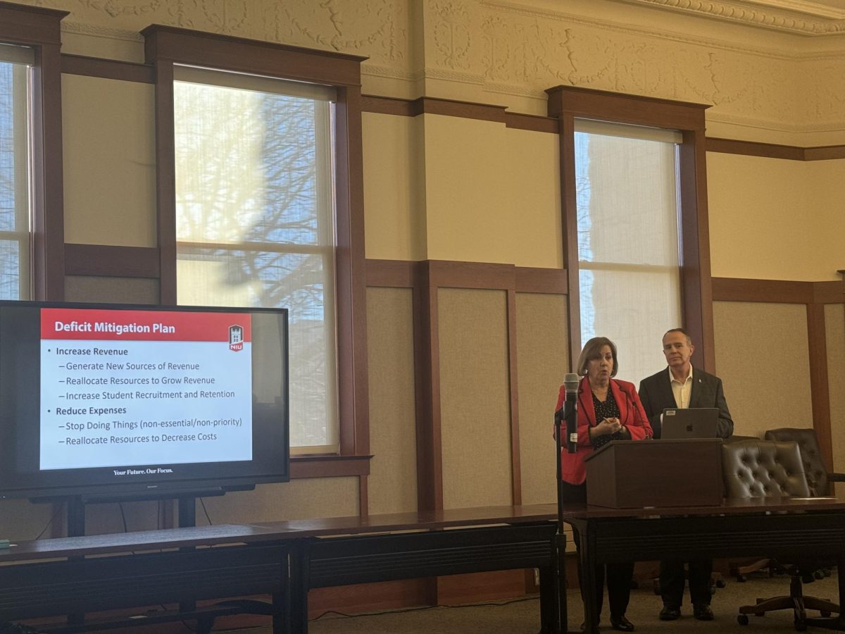 Executive Vice President and Provost Laurie Elish-Piper (left) and Vice President and Chief Financial Officer George Middlemist give a presentation about NIU's deficit mitigation plan. NIU plans on reducing the deficit to $15.4 million by the end of fiscal year 2025 and to $0 by the end of fiscal year 2026. (Northern Star File Photo)