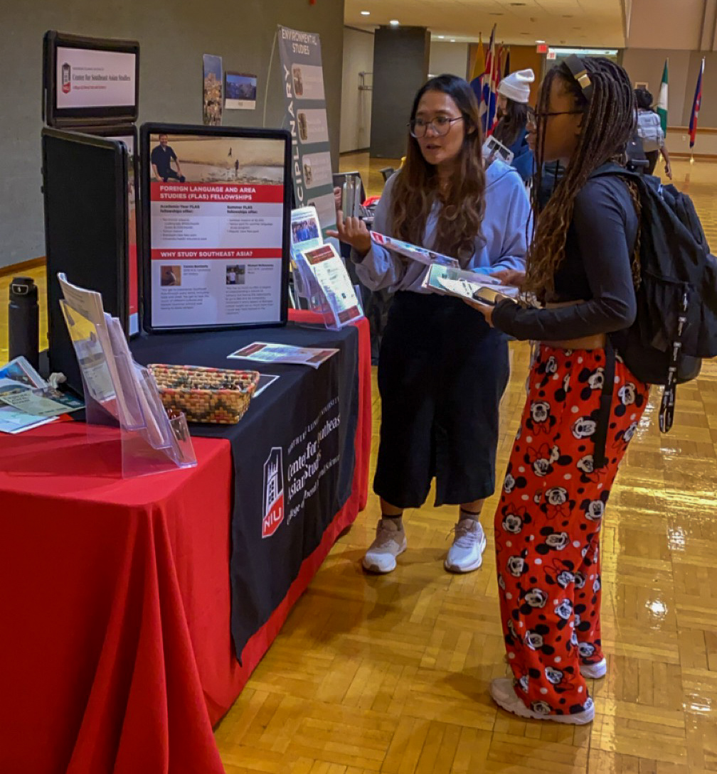 First-year student Nia Syrai' Harris, a computer science major, engages in conversation with sophomore May Swe Oo, an education major at the Study Abroad Fair. The Study Abroad Fair provided students the opportunity to learn information about how to study abroad. (Zahra Yousif | Northern Star)