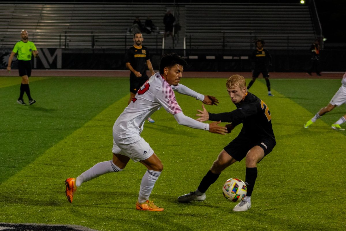 Redshirt freshman midfielder Joe Hernandez (left) battles for the ball with University of Wisconsin-Milwaukee redshirt sophomore defender Mitch Goodman on Tuesday at the NIU Soccer and Track & Field Complex. NIU men's soccer was shut out for the second game in a row as the Huskies lost 2-0 to Milwaukee. (Totus Tuus Keely | Northern Star)