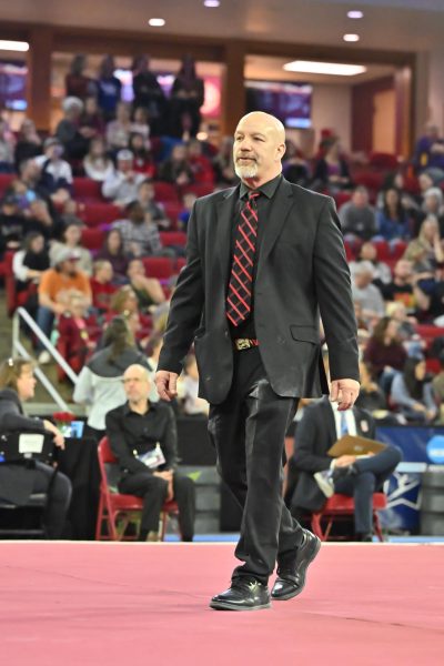 Recently-retired NIU head gymnastics coach Sam Morreale walks on the floor during a gymnastics meet. The school announced Morreale’s retirement Thursday after a 13-year head coaching tenure with the program. (Courtesy of NIU Athletics)