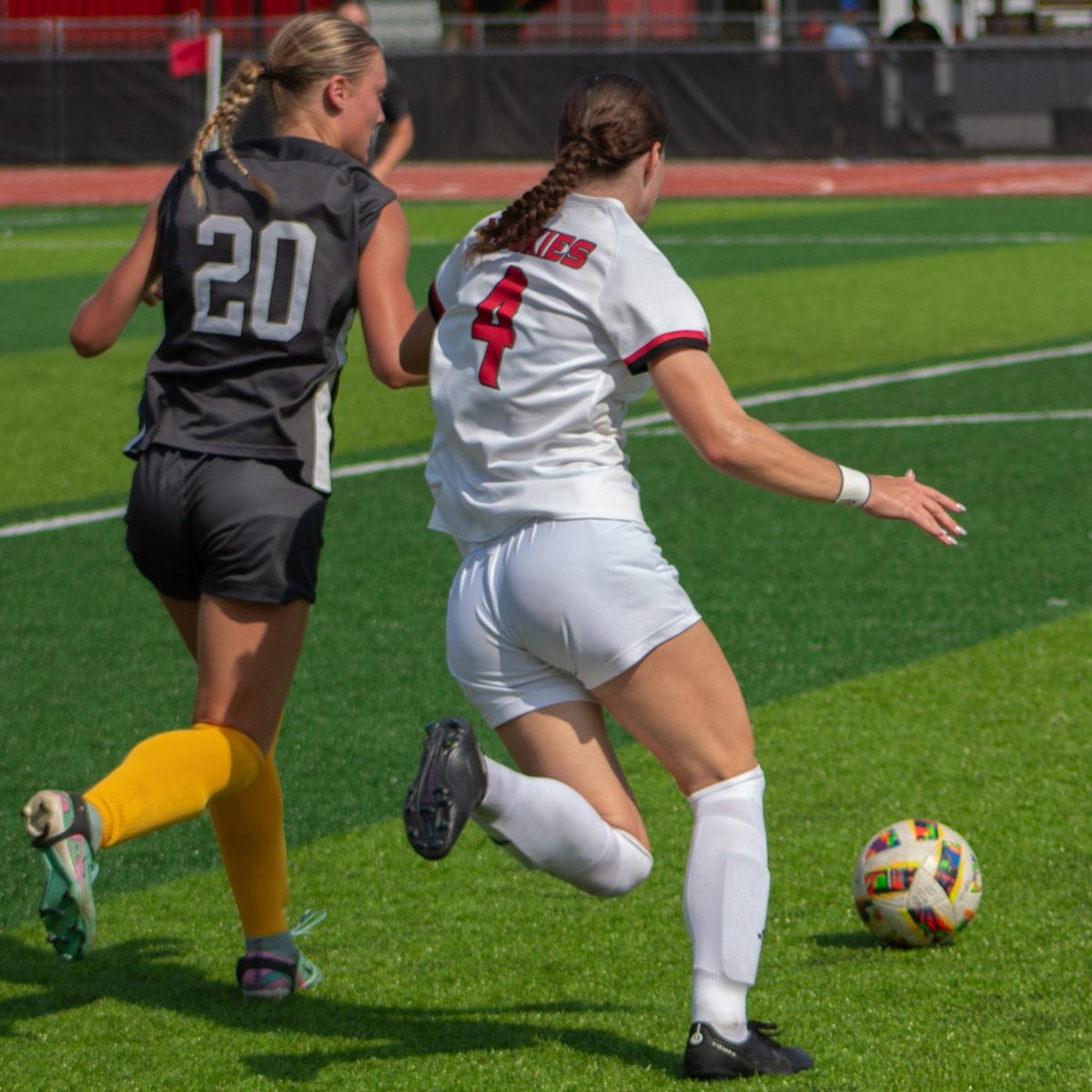 Junior forward Kelsi McLaughlin (4) beats Valparaiso freshman defender Ashley Trippeer (20) to the ball. McLaughlin was named the MAC Offensive Player of the Week on Tuesday after scoring a goal in each of the past two games for NIU women's soccer. (Northern Star File Photo)